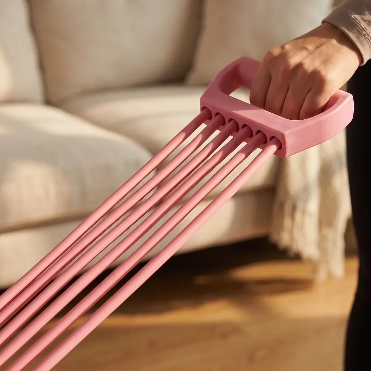 Close-up of the six natural rubber tubes meeting a handle, stretched under tension